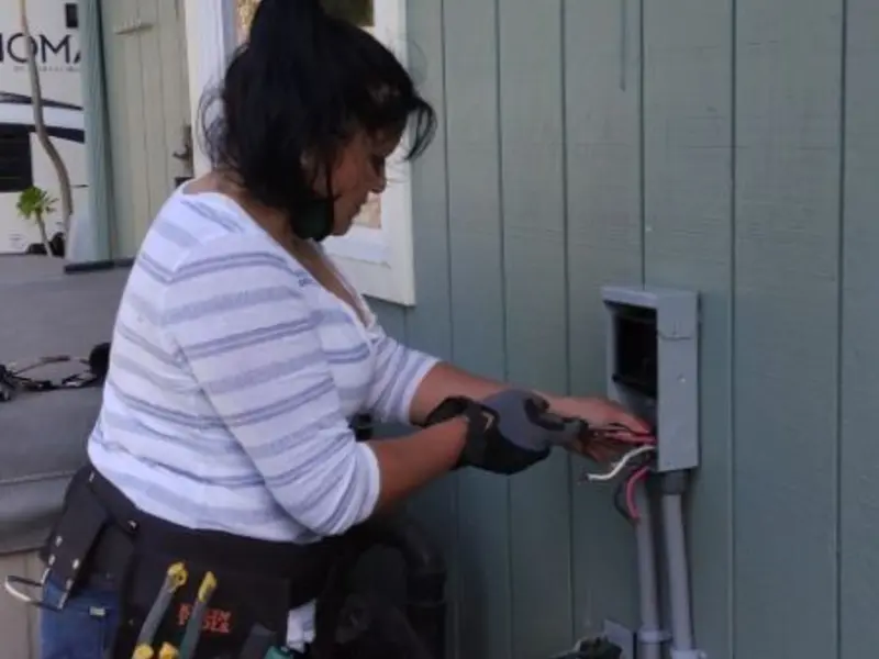 Licensed electrician wiring an exterior subpanel in Swansboro